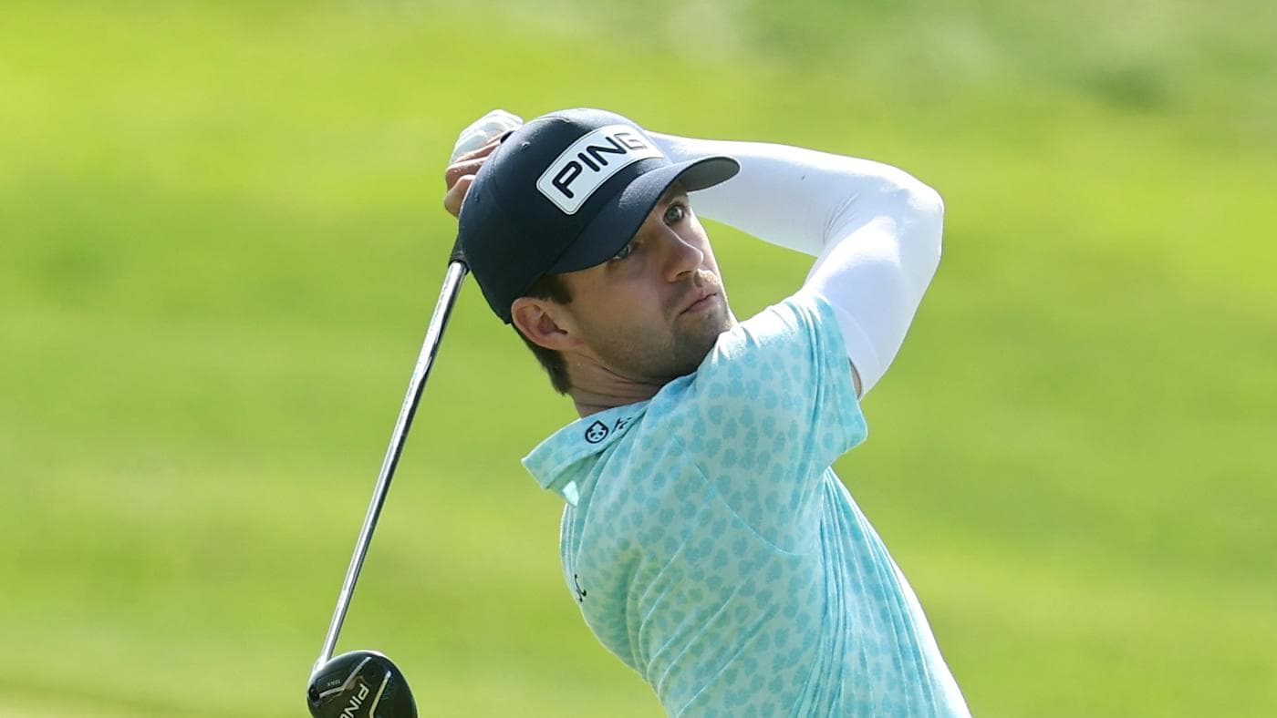 Alex Smalley in a white cap and black shirt, fist raised at the 2026 PGA Championship.