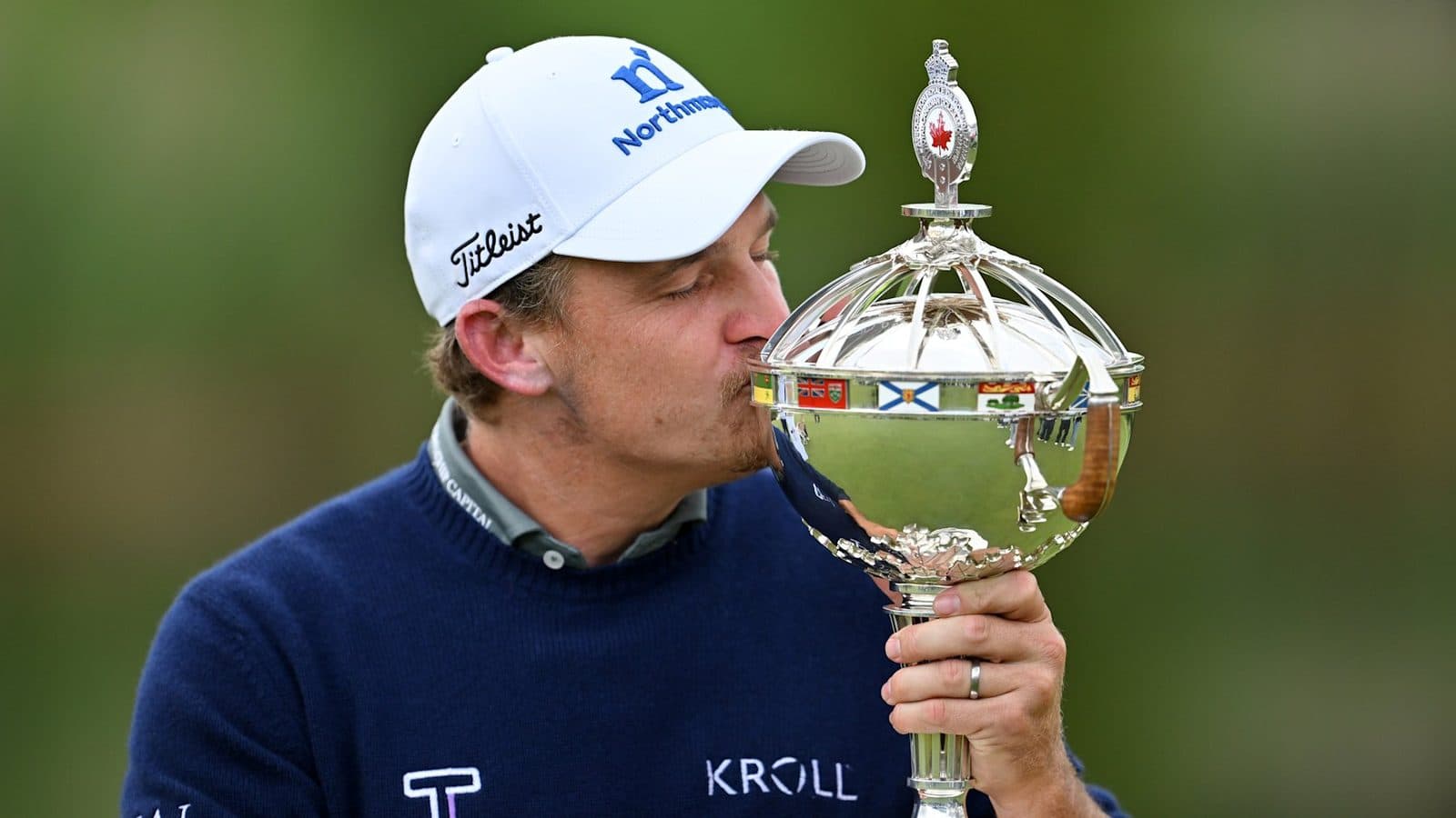 Bud Cauley kissing the RBC Canadian Open trophy.