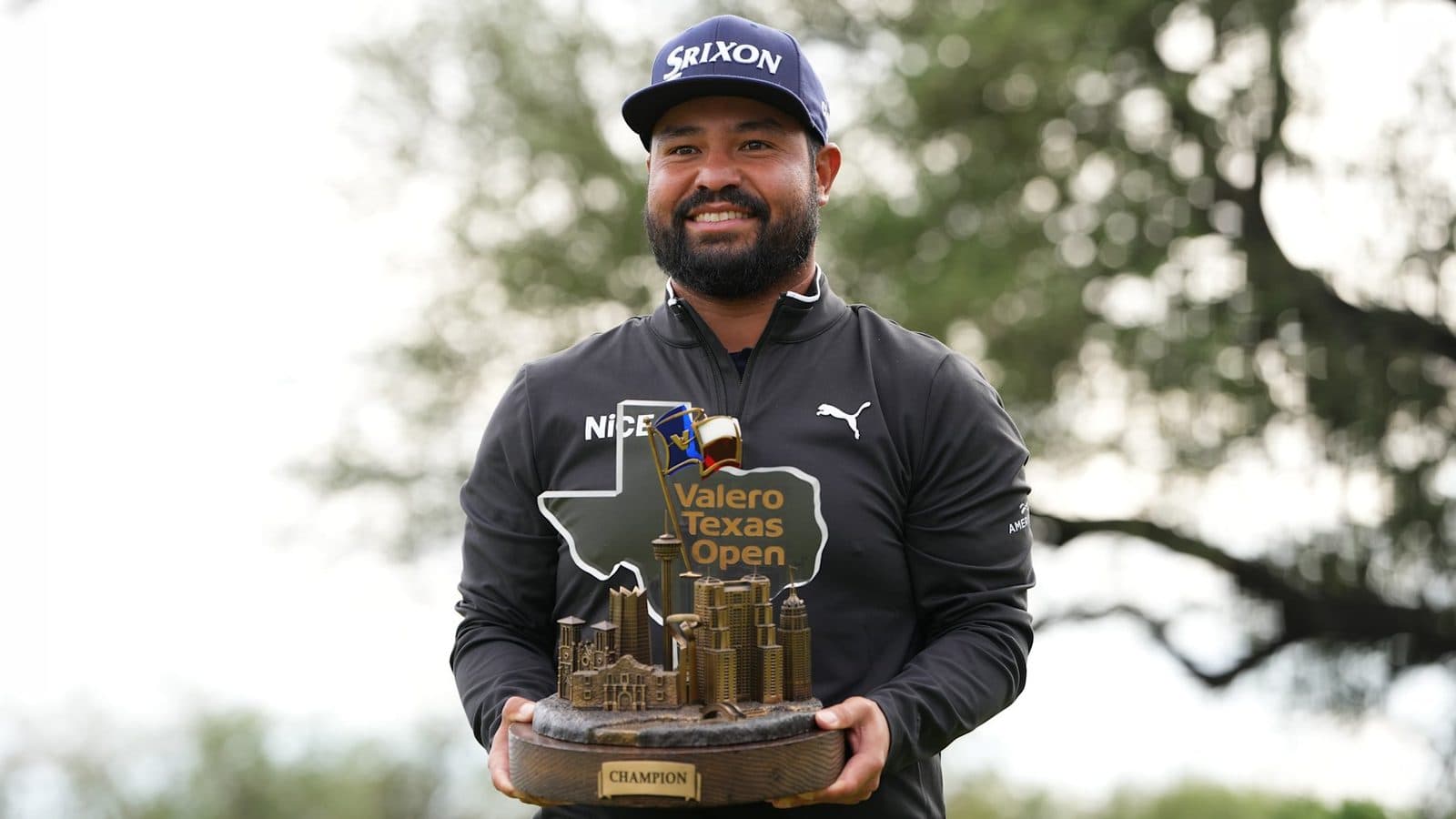 J. J. Spaun holding the Valero Texas Open trophy.