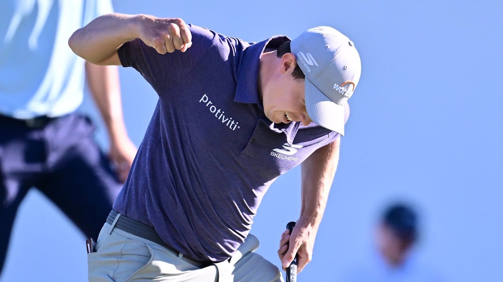 Matt Fitzpatrick in a white shirt and cap, fist pumped after a putt at the Valspar Championship.
